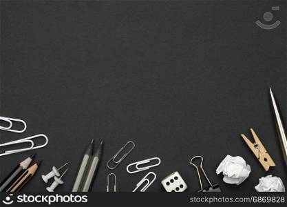 Office accessories on black paper background. Minimal style. Copy space. Top view