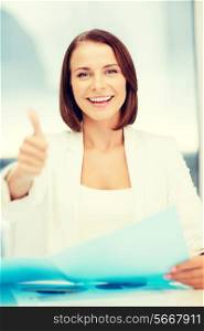 office and business concept - smiling attractive businesswoman showing thumbs up in office