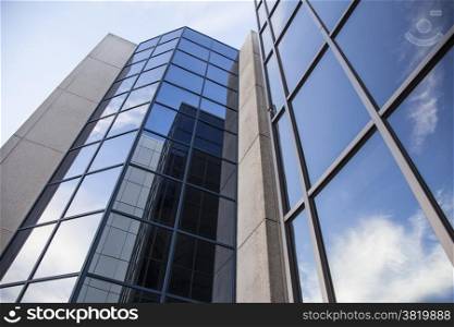 office building and reflections of clouds in blue sky
