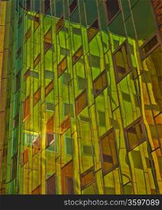 Office building with green, yellow and orange reflexions in windows
