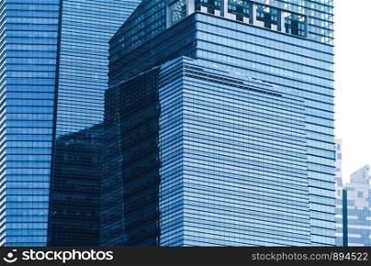 Office buildings windows. Blue glass architecture facade design with reflection of sky in urban city, Downtown Singapore City in financial district.
