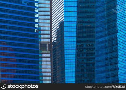 Office buildings windows. Blue glass architecture facade design with reflection of sky in urban city, Downtown Singapore City in financial district.