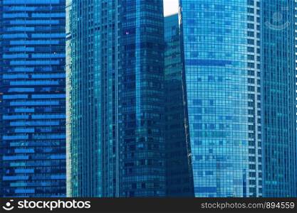Office buildings windows. Blue glass architecture facade design with reflection of sky in urban city, Downtown Singapore City in financial district.