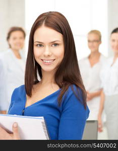 office, buisness, education concept - happy woman with big notepad