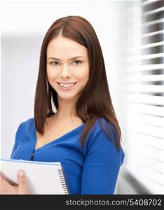 office, buisness, education concept - happy woman with big notepad