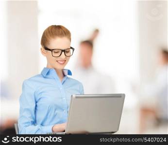 office, buisness, education concept - smiling woman using her laptop computer