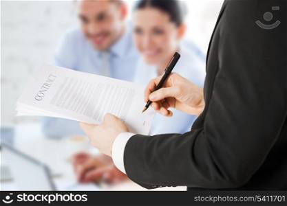 office, buisness, legal, teamwork concept - man signing contract
