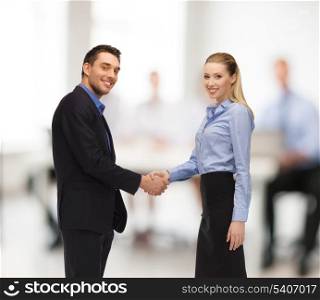 office, buisness, teamwork concept - man and woman shaking their hands