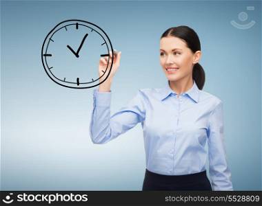 office, business and future technology concept - businesswoman drawing clock in the air with marker