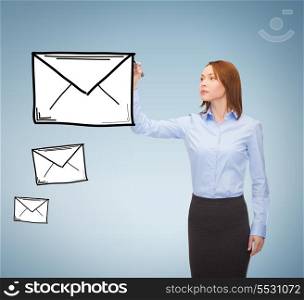 office, business and new technology concept - smiling businesswoman drawing envelope on virtual screen