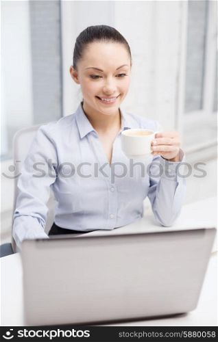 office, business and technology concept - smiling businesswoman or student with laptop computer and coffee in office