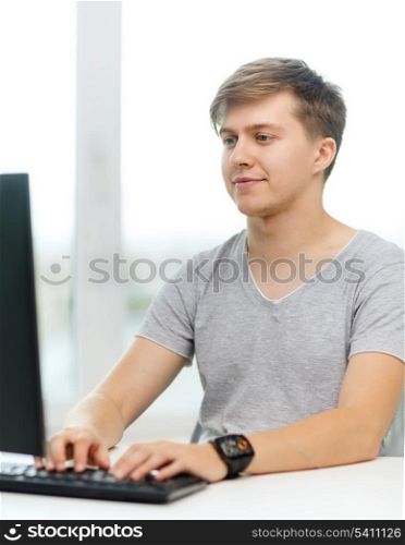 office, business, education, technology and internet concept - smiling student with computer