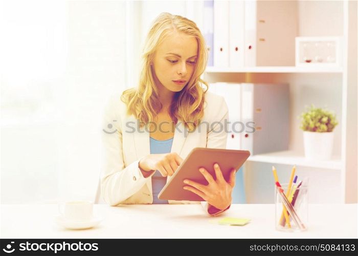 office, business, education, technology and people concept - businesswoman or student with tablet pc computer sitting at table. businesswoman or student with tablet pc at office. businesswoman or student with tablet pc at office