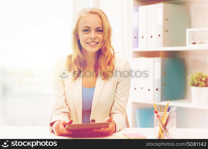 office, business, education, technology and people concept - smiling businesswoman or student with tablet pc computer sitting at table. businesswoman or student with tablet pc at office