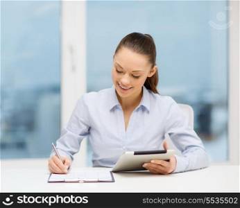 office, business, technology and internet concept - businesswoman with tablet pc and documents in office