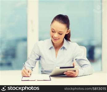 office, business, technology and internet concept - businesswoman with tablet pc and documents in office