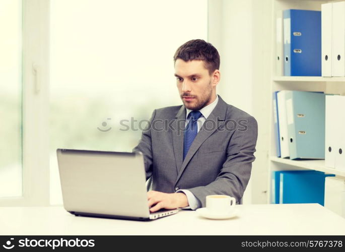 office, business, technology and internet concept - busy businessman with laptop computer and coffee at office