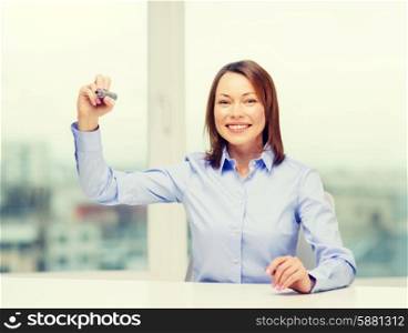 office, business, technology concept - businesswoman writing something in the air with marker