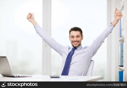 office, business, technology, finances and internet concept - smiling businessman with laptop computer and documents at office