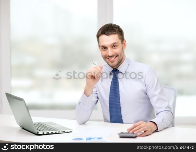 office, business, technology, finances and internet concept - smiling businessman with laptop computer and documents at office