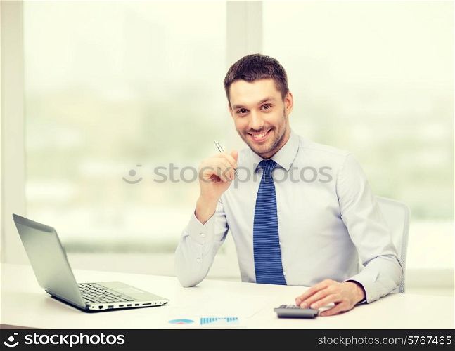 office, business, technology, finances and internet concept - smiling businessman with laptop computer and documents at office