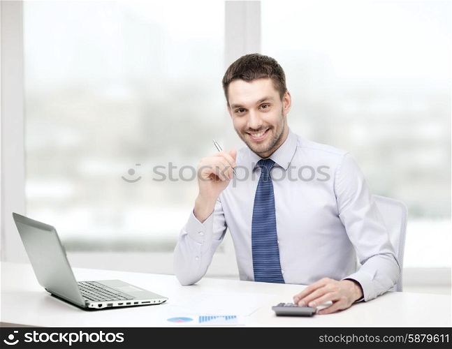 office, business, technology, finances and internet concept - smiling businessman with laptop computer and documents at office