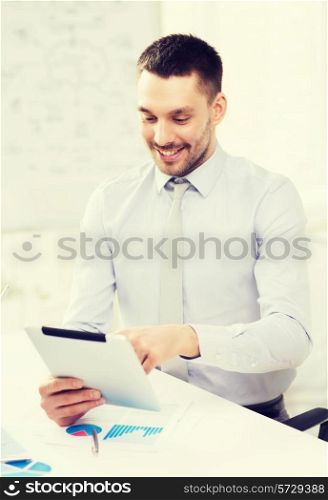 office, business, technology, finances and internet concept - smiling businessman with tablet pc computer and documents in office