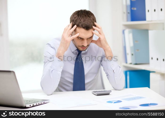 office, business, technology, finances and internet concept - stressed businessman with laptop computer and documents at office