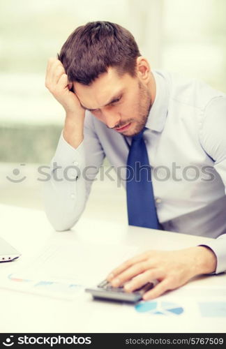 office, business, technology, finances and internet concept - stressed businessman with laptop computer and documents at office