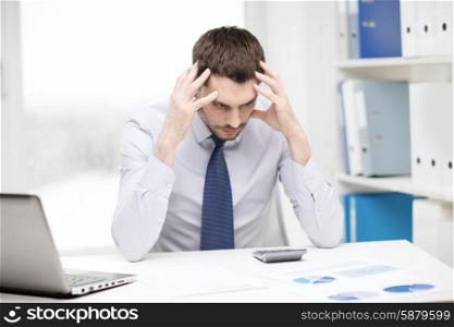 office, business, technology, finances and internet concept - stressed businessman with laptop computer and documents at office