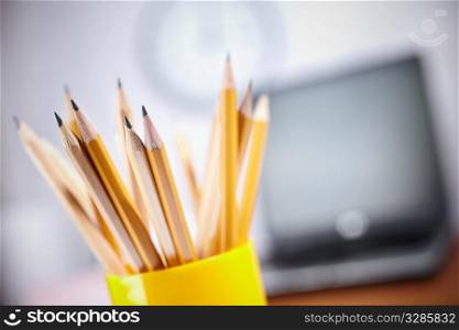 office concept with different pencils in close up, selective focus on nearest, shallow depth of field