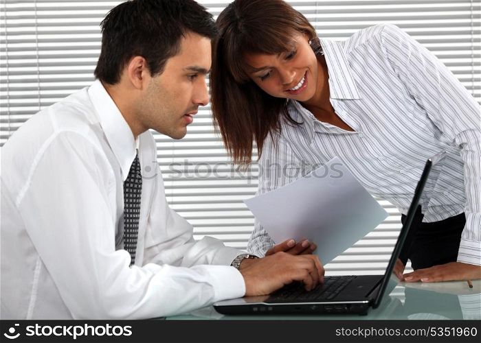 Office couple with a laptop