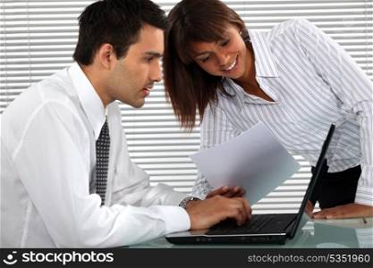 Office couple with a laptop