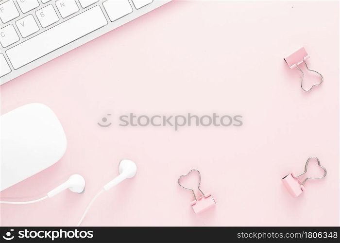 Office desk table top view with office supply, pink table with copy space, pink color workplace composition, flat lay