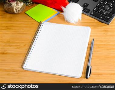 office desk with christmas accessories and stationery, view from above