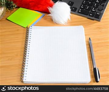 office desk with christmas accessories and stationery, view from above