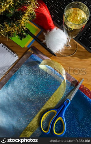 office desk with christmas accessories, wrapping paper for presents and stationery, view from above