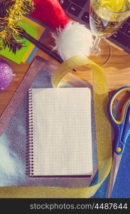 office desk with christmas accessories, wrapping paper for presents and stationery, view from above