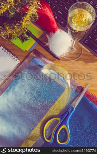 office desk with christmas accessories, wrapping paper for presents and stationery, view from above