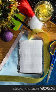 office desk with christmas accessories, wrapping paper for presents and stationery, view from above