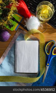 office desk with christmas accessories, wrapping paper for presents and stationery, view from above