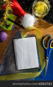 office desk with christmas accessories, wrapping paper for presents and stationery, view from above