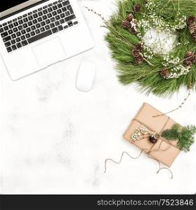 Office desk with Christmas decoration and wrapped gift. Business Holidays Concept