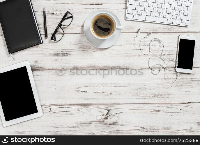 Office desk with cup of coffee, tablet pc, mobile phone. Business background with space for your text image picture. Flat lay
