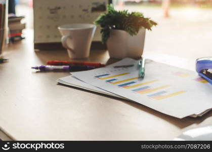 Office desk workplace graph and pen on table.