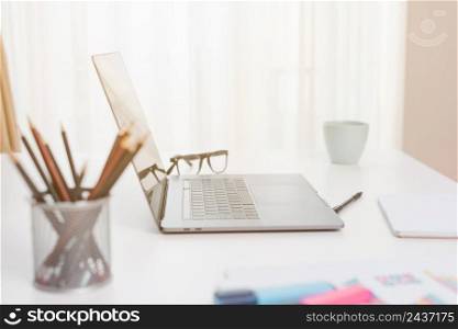 office desktop with laptop glasses