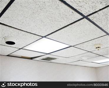 Office drop ceiling with white flourescent lights