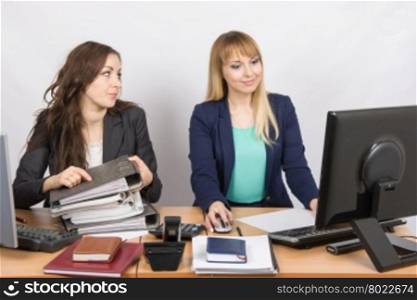Office employee asks for help from colleagues at work with papers and documents