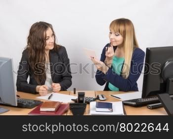 Office employee observes as lipstick colleague sitting beside his desk