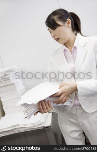 Office lady putting documents in order